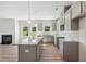 Kitchen and dining area featuring gray cabinets, granite countertops, stainless steel appliances and a fireplace at 11847 Rizvan Pl, Covington, GA 30014