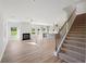 Open-concept living area, staircase, and kitchen with abundant natural light at 11847 Rizvan Pl, Covington, GA 30014