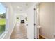 Open-concept living area with fireplace and view into powder room at 11847 Rizvan Pl, Covington, GA 30014