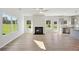 Open-concept living area featuring a fireplace and abundant natural light at 11847 Rizvan Pl, Covington, GA 30014