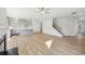 Open concept kitchen, living room, and staircase, all featuring wood-look floors and stainless appliances at 11847 Rizvan Pl, Covington, GA 30014
