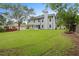 Beautifully maintained backyard showing a large green lawn, trees, and the home's exterior at 160 Magnolia Walk Ln, South Fulton, GA 30349