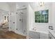 Bright bathroom featuring a large, enclosed shower, garden tub, and elegant fixtures at 160 Magnolia Walk Ln, South Fulton, GA 30349