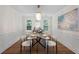 Formal dining room with modern chandelier, wainscoting, and natural light at 160 Magnolia Walk Ln, South Fulton, GA 30349