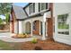 Close-up of front entrance showing covered porch and manicured landscaping at 160 Magnolia Walk Ln, South Fulton, GA 30349