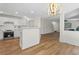 Updated kitchen with white cabinets and stainless steel appliances flows into the living room at 160 Magnolia Walk Ln, South Fulton, GA 30349