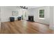 Spacious living room with vinyl floors, fan, fireplace, and large windows for great natural lighting at 160 Magnolia Walk Ln, South Fulton, GA 30349