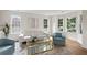 Bright living room boasts ample sunlight, modern decor, and hardwood floors at 160 Magnolia Walk Ln, South Fulton, GA 30349