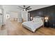 Expansive main bedroom with black accent wall and ensuite bath, exuding modern elegance at 160 Magnolia Walk Ln, South Fulton, GA 30349