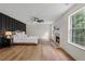 Sunlit main bedroom with a cozy fireplace, views through bright windows, and a luxury accent wall at 160 Magnolia Walk Ln, South Fulton, GA 30349