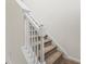Carpeted staircase with white handrail provides access to the upper level of the home at 160 Magnolia Walk Ln, South Fulton, GA 30349