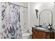 Well-lit bathroom featuring a tub with shower and vanity with granite countertop at 1701 Tipton Nw Ct, Acworth, GA 30101