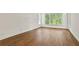 Well lit room boasts a large window with lush, green views and gleaming hardwood floors at 1701 Tipton Nw Ct, Acworth, GA 30101