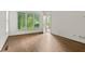 Comfortable bedroom with gleaming hardwood floors, large windows, and a door to the outside at 1701 Tipton Nw Ct, Acworth, GA 30101