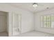 Carpeted bedroom with ensuite bath and window with plantation shutters for natural light at 1701 Tipton Nw Ct, Acworth, GA 30101