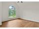 Large bedroom with hardwood floors and view to the backyard and golf course at 1701 Tipton Nw Ct, Acworth, GA 30101