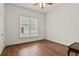 Bright bedroom featuring hardwood floors and a large window allowing for natural light at 1701 Tipton Nw Ct, Acworth, GA 30101