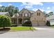 Charming brick home featuring a manicured front yard and a welcoming two-car garage at 1701 Tipton Nw Ct, Acworth, GA 30101