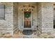 Elegant front door with a wreath, stone accents, and covered entryway at 1701 Tipton Nw Ct, Acworth, GA 30101