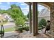 Charming front porch view with stone flooring and serene neighborhood setting at 1701 Tipton Nw Ct, Acworth, GA 30101