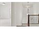Hallway featuring high ceilings with an elegant pendant light and wood and iron banister at 1701 Tipton Nw Ct, Acworth, GA 30101