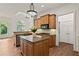 Open kitchen with island, granite countertops, stainless appliances, and a large window at 1701 Tipton Nw Ct, Acworth, GA 30101
