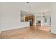 Open-concept living space featuring hardwood floors, kitchen access, and brick fireplace at 1701 Tipton Nw Ct, Acworth, GA 30101