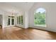 Bright living room with hardwood floors, large windows, and views of the backyard at 1701 Tipton Nw Ct, Acworth, GA 30101