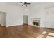 Spacious living room featuring a stone fireplace, built-in cabinets, and beautiful hardwood floors at 1701 Tipton Nw Ct, Acworth, GA 30101