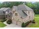 Rear exterior showcasing the two-car garage and a well-maintained lawn at 1701 Tipton Nw Ct, Acworth, GA 30101