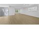 Finished basement featuring wood floor, natural light, and sliding door at 400 Hunt River Way, Suwanee, GA 30024