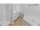 Bathroom featuring tub, separate shower, double sinks and a large mirror at 400 Hunt River Way, Suwanee, GA 30024
