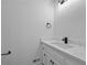 Bathroom features a white vanity with quartz countertops, black hardware and faucet, and wood grain floors at 400 Hunt River Way, Suwanee, GA 30024