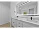 Bathroom featuring double sink vanity, large mirror, and modern fixtures at 400 Hunt River Way, Suwanee, GA 30024