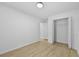Clean bedroom with wood-look flooring, a standard closet, and neutral color palette at 400 Hunt River Way, Suwanee, GA 30024