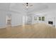 View of a Primary bedroom featuring light floors, fireplace, and ensuite bathroom at 400 Hunt River Way, Suwanee, GA 30024