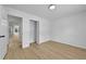 Empty bedroom with wood grain floors connects to another room and has a closet at 400 Hunt River Way, Suwanee, GA 30024