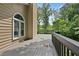 Side view of the wood deck with vinyl siding, trees, and natural light at 400 Hunt River Way, Suwanee, GA 30024