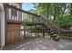 Multi-level wood deck system that leads to a wooded backyard at 400 Hunt River Way, Suwanee, GA 30024