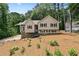 Charming tan home with stone accents, black shutters, and landscaped front yard at 400 Hunt River Way, Suwanee, GA 30024