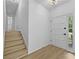 Bright and airy foyer with luxury vinyl flooring and staircase at 400 Hunt River Way, Suwanee, GA 30024