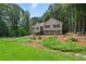 Inviting two-story home with manicured lawn and lush green surroundings at 400 Hunt River Way, Suwanee, GA 30024