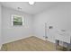 Bright laundry room with window, utility sink, and neutral walls at 400 Hunt River Way, Suwanee, GA 30024