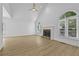 Spacious living room with vaulted ceilings, fireplace, and luxury vinyl flooring at 400 Hunt River Way, Suwanee, GA 30024