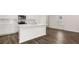 Spacious kitchen with island, white cabinetry, stainless appliances, and luxury vinyl flooring at 560 Silver Moon Dr, Loganville, GA 30052