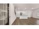 Open concept living and kitchen area, featuring luxury vinyl flooring, white cabinets, and stainless appliances at 560 Silver Moon Dr, Loganville, GA 30052