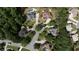 An aerial view of a community featuring large homes with lush landscaping and mature trees at 200 Long Needle Ct, Sugar Hill, GA 30518