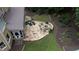 Aerial view of a backyard with a stone patio, fire pit, and landscaped garden at 200 Long Needle Ct, Sugar Hill, GA 30518