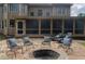 Outdoor stone patio featuring a fire pit and outdoor seating that creates a cozy atmosphere at 200 Long Needle Ct, Sugar Hill, GA 30518