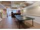 Basement featuring a ping pong table, bar area, tile flooring, and access to the backyard at 200 Long Needle Ct, Sugar Hill, GA 30518